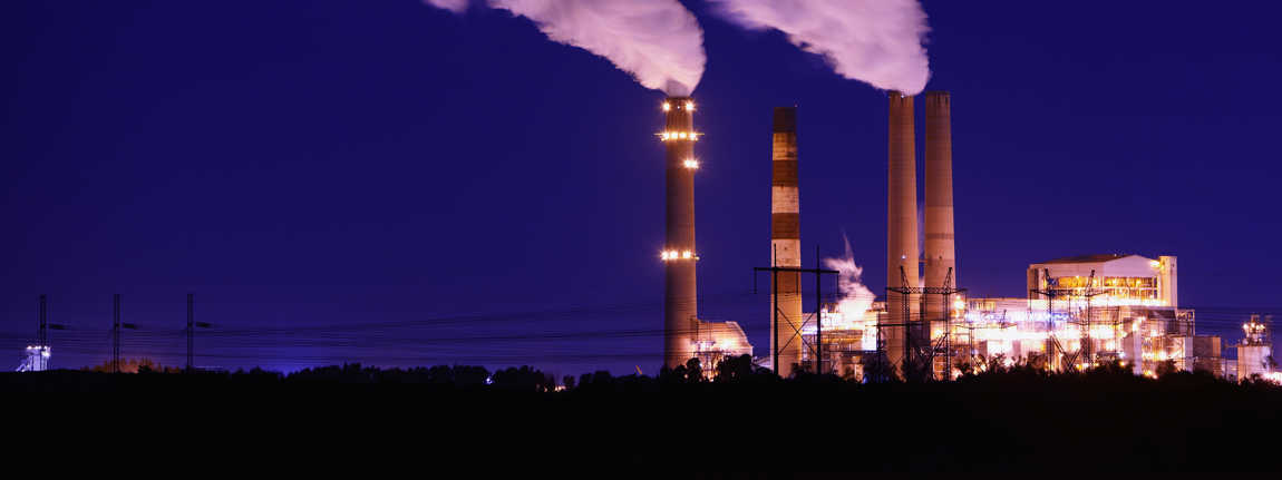 Smokestacks Billowing Smoke At Night