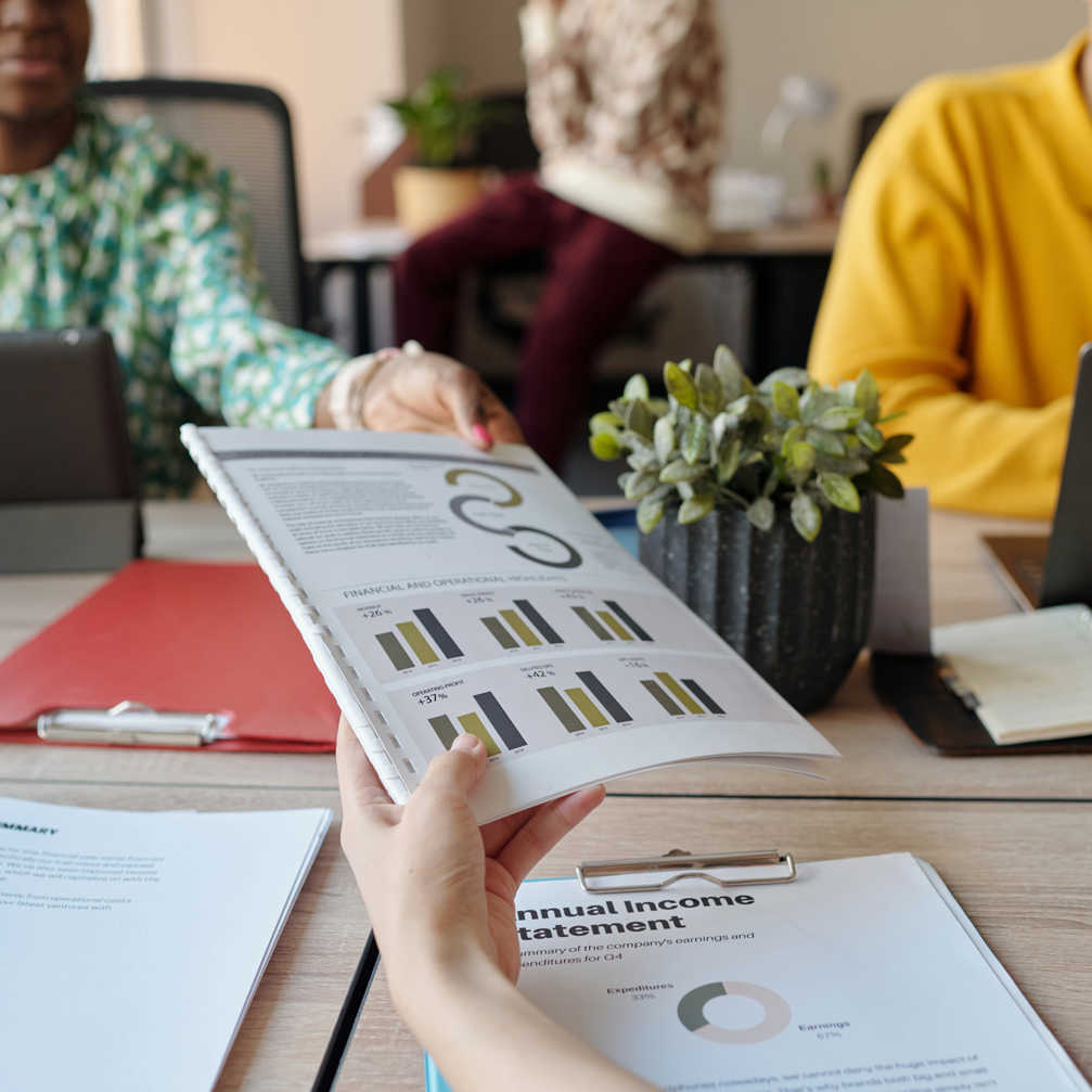 Handing Financial Report To Young Adult Coworkers